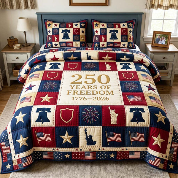 Freedom Legacy quilted 3-piece bedding set on a made bed in a warmly lit bedroom