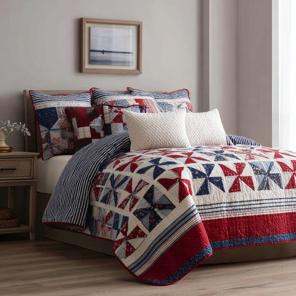 Freedom Spirit quilted 3-piece bedding set on a made bed in a warmly lit bedroom