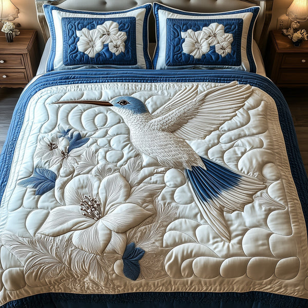 Frosted Hummingbird quilted 3-piece bedding set on a made bed in a winter-styled bedroom