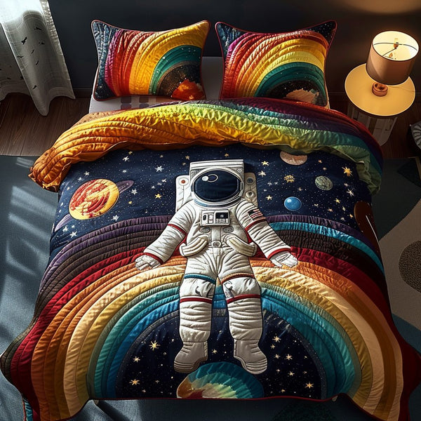 Galactic Explorer quilted 3-piece bedding set on a made bed with two matching pillow shams