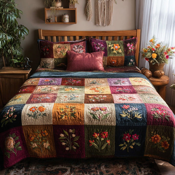 Garden Blooms quilted 3-piece bedding set on a made bed with two matching pillow shams