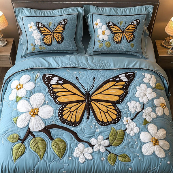 Garden Flight quilted 3-piece bedding set on a made bed with two matching pillow shams