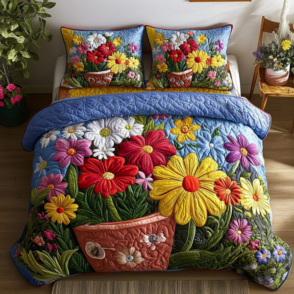 Garden Glow quilted 3-piece bedding set on a made bed with two matching pillow shams