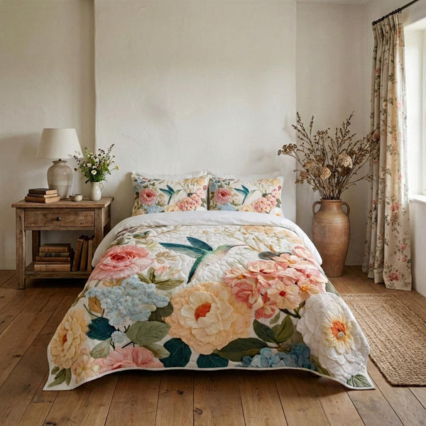 Garden Hummingbird quilted 3-piece bedding set on a made bed with two matching pillow shams
