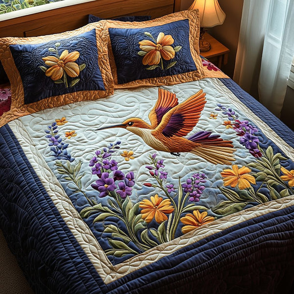Garden Wings quilted 3-piece bedding set on a made bed with two matching pillow shams