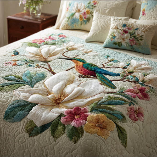 Garden Wings quilted 3-piece bedding set on a made bed with two matching pillow shams