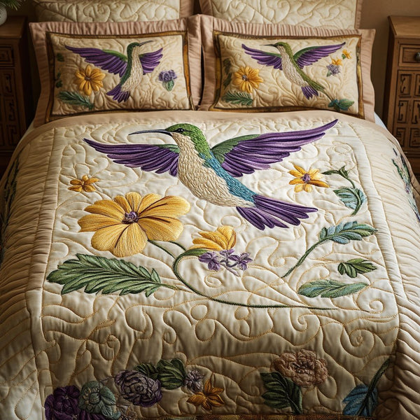 Garden Wings quilted 3-piece bedding set on a made bed with two matching pillow shams