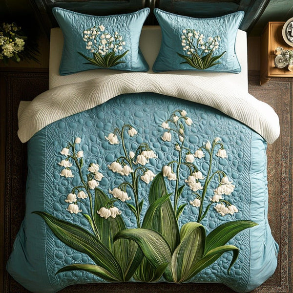 Gentle Bells quilted 3-piece bedding set on a made bed with two matching pillow shams