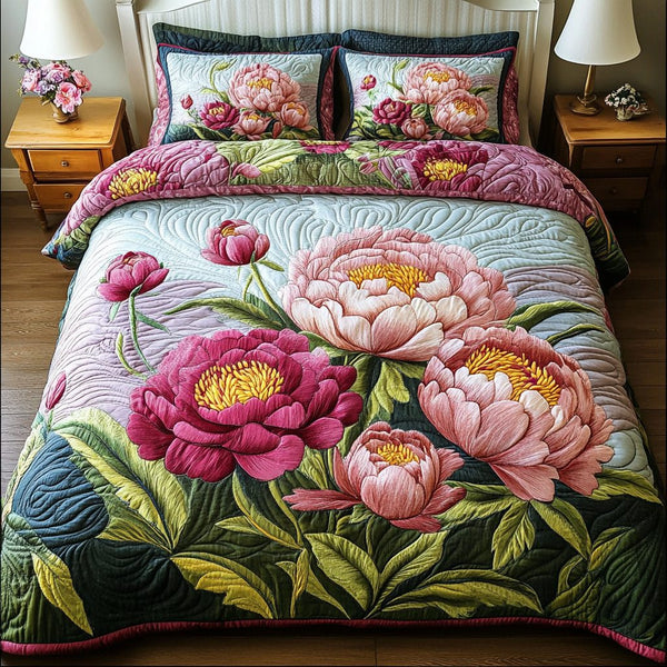 Gentle Bloom quilted 3-piece bedding set on a made bed with two matching pillow shams