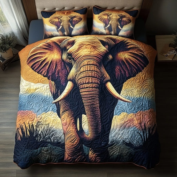 Gentle Elephant quilted 3-piece bedding set on a made bed with two matching pillow shams