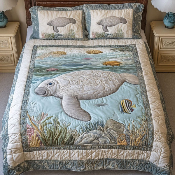 Gentle Sea Giant quilted 3-piece bedding set on a made bed in a light coastal bedroom