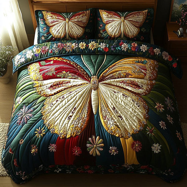 Gilded Wings quilted 3-piece bedding set on a made bed with two matching pillow shams