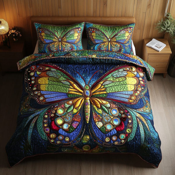 Gliding Beauty quilted 3-piece bedding set on a made bed with two matching pillow shams
