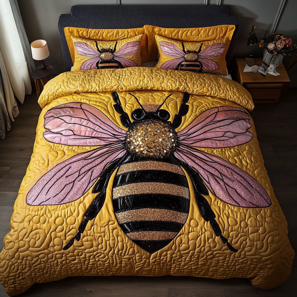 Glitter Bee Charm quilted 3-piece bedding set on a made bed with two matching pillow shams