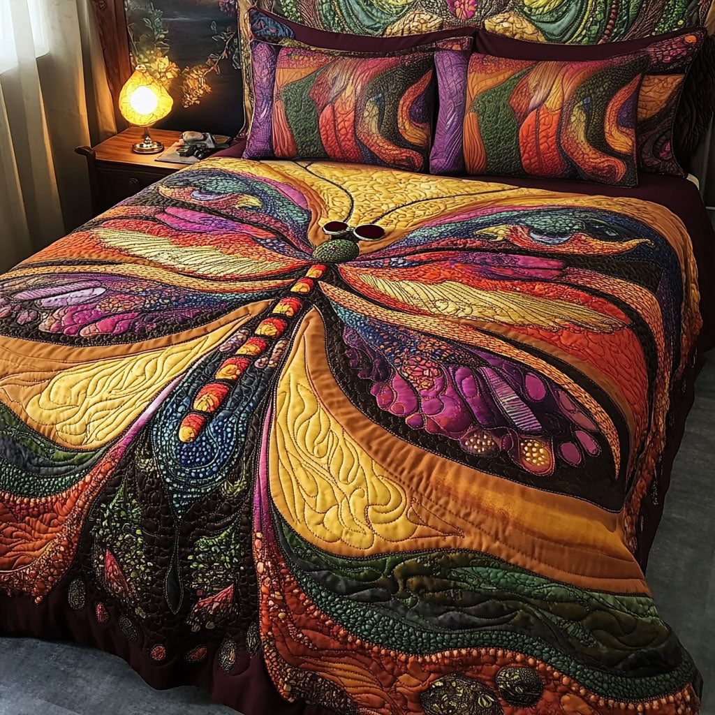 Glowing Wings quilted 3-piece bedding set on a made bed with two matching pillow shams