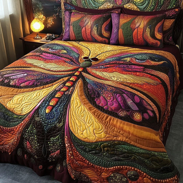 Glowing Wings quilted 3-piece bedding set on a made bed with two matching pillow shams