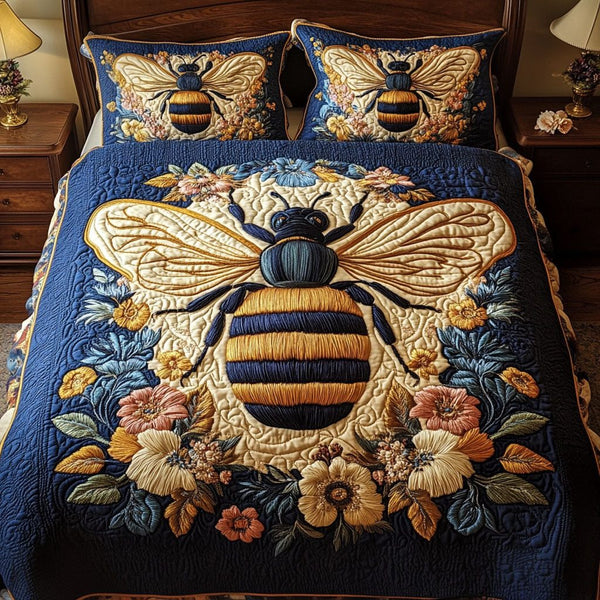 Golden Bee Blossom quilted 3-piece bedding set on a made bed with two matching pillow shams