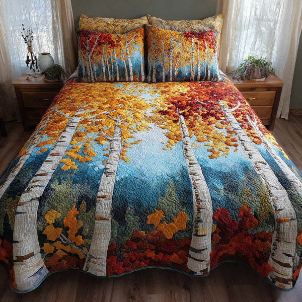 Golden Birches quilted 3-piece bedding set on a made bed with two matching pillow shams