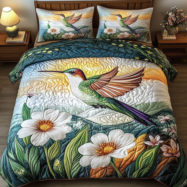 Golden Dawn Hummingbird quilted 3-piece bedding set on a made bed with two matching pillow shams