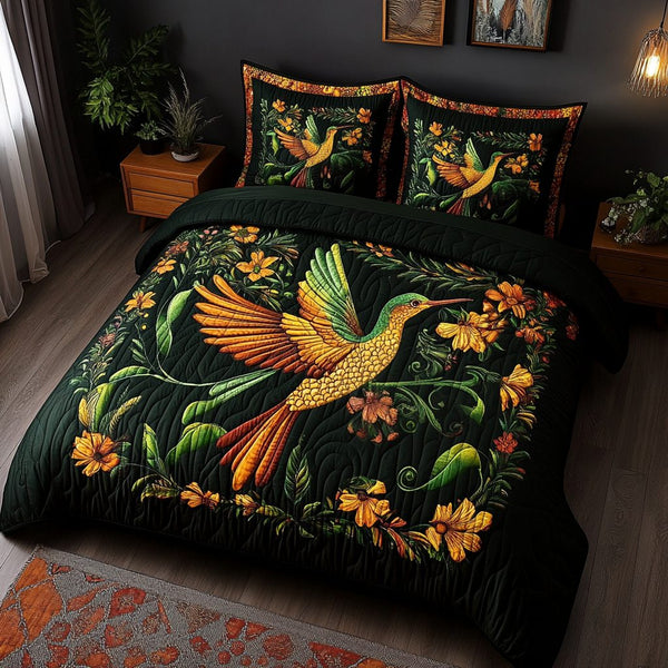 Golden Garden Hummingbird quilted 3-piece bedding set on a made bed with two matching pillow shams