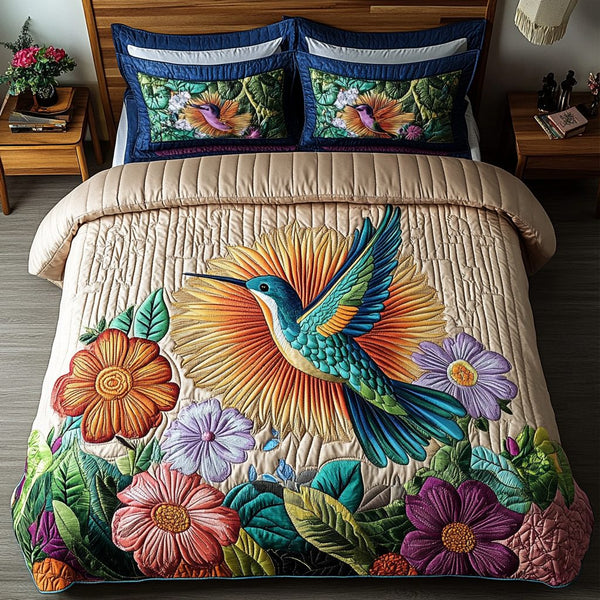 Golden Glow Hummingbird quilted 3-piece bedding set on a made bed with two matching pillow shams