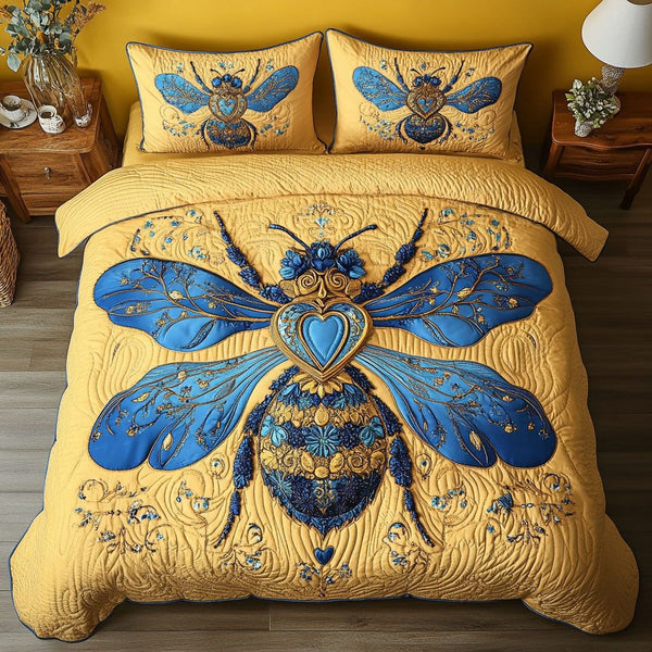 Golden Heart Bee quilted 3-piece bedding set on a made bed with two matching pillow shams