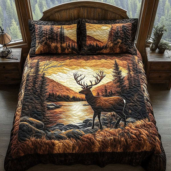 Golden Hour Elk quilted 3-piece bedding set on a made bed with two matching pillow shams