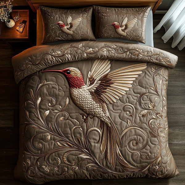 Golden Hummingbird quilted 3-piece bedding set on a made bed with two matching pillow shams