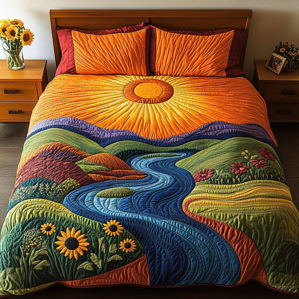 Golden Sunrise River quilted 3-piece bedding set on a made bed with two matching pillow shams