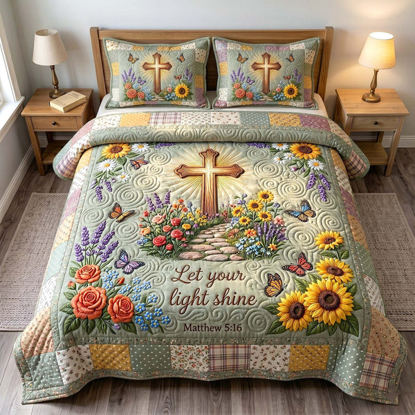 Grace In Bloom quilted 3-piece bedding set on a made bed with two matching pillow shams