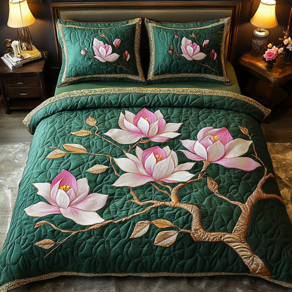 Green Magnolia Beauty quilted 3-piece bedding set on a made bed with two matching pillow shams