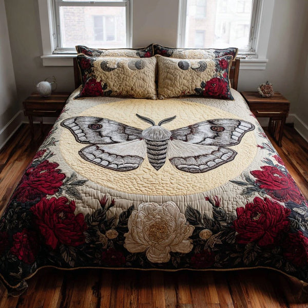 Grey Moth quilted 3-piece bedding set on a made bed with two matching pillow shams