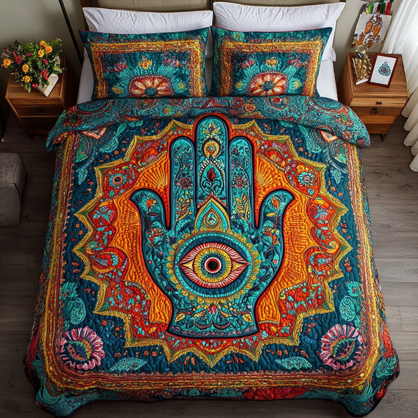 Hamsa Grace quilted 3-piece bedding set on a made bed with two matching pillow shams