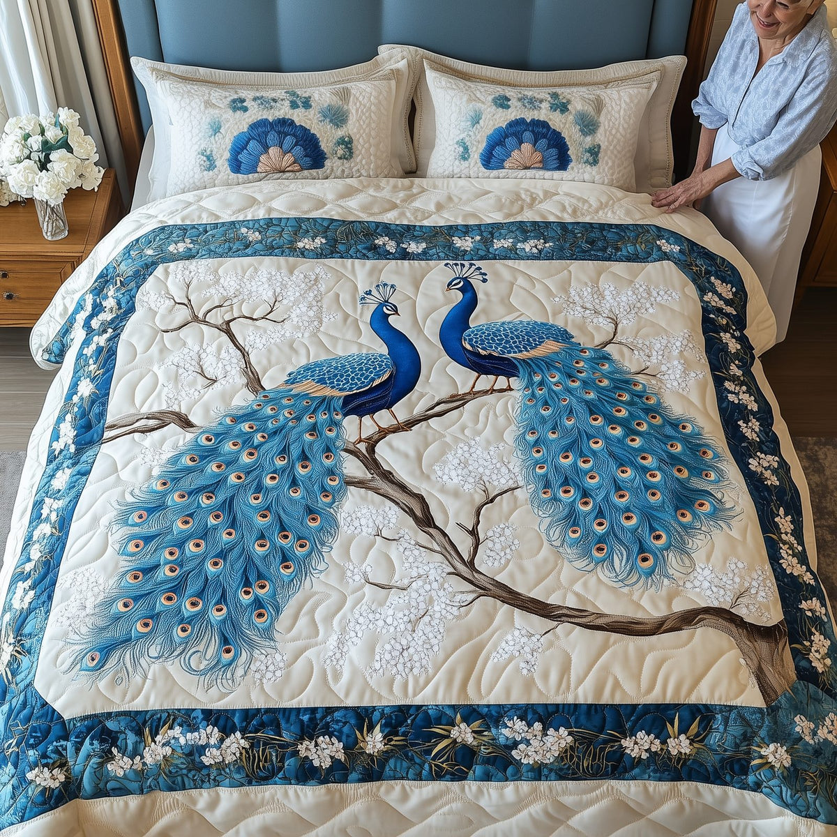 Happily Ever Peacocks quilted 3-piece bedding set on a made bed with two matching pillow shams