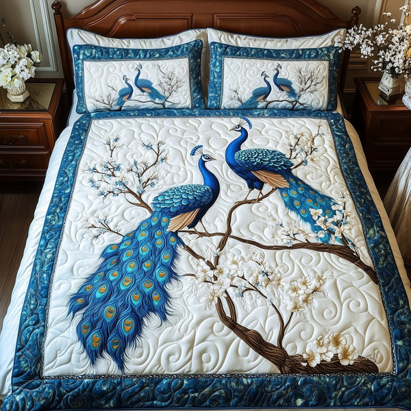 Happily Ever Peacocks quilted 3-piece bedding set on a made bed with two matching pillow shams