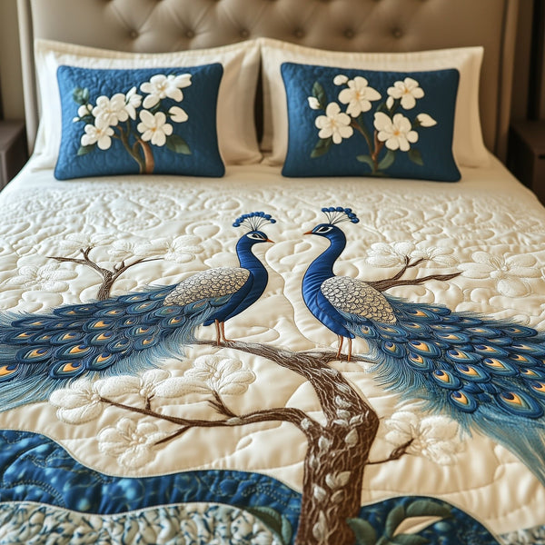 Happily Ever Peacocks quilted 3-piece bedding set on a made bed with two matching pillow shams