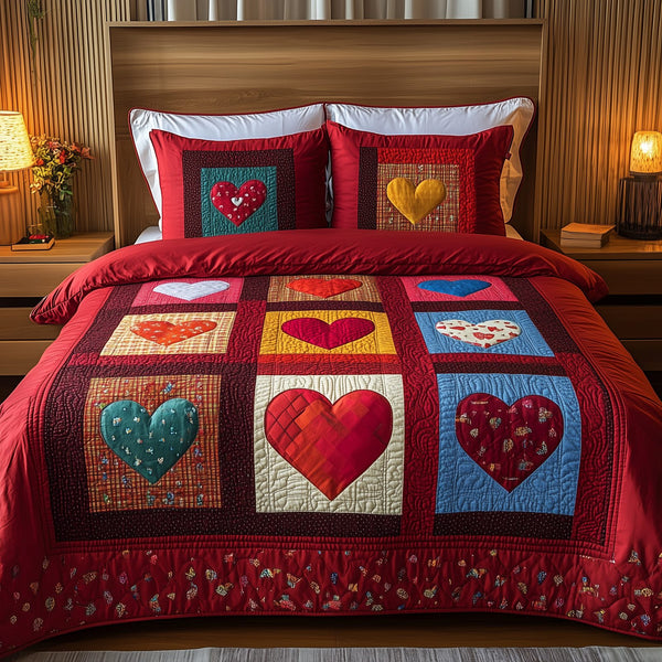 Heart By Heart quilted 3-piece bedding set on a made bed with two matching pillow shams