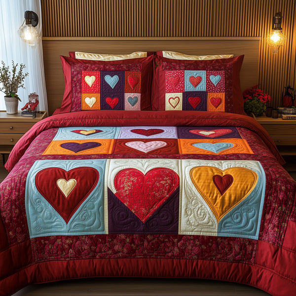 Heart By Heart quilted 3-piece bedding set on a made bed with two matching pillow shams