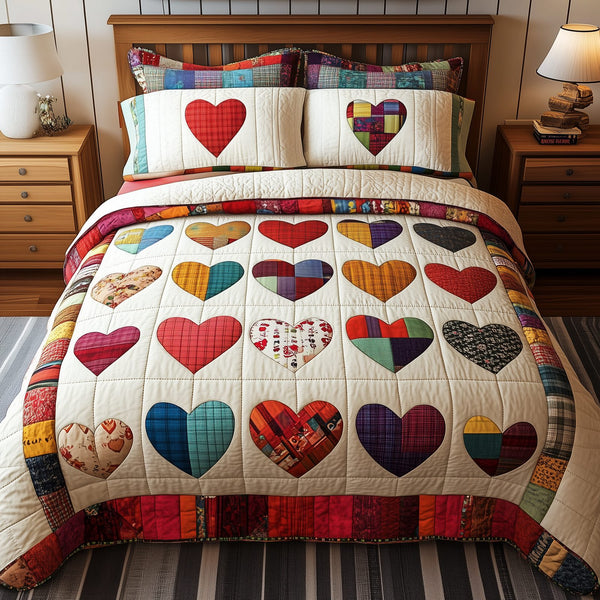 Heart By Heart quilted 3-piece bedding set on a made bed with two matching pillow shams