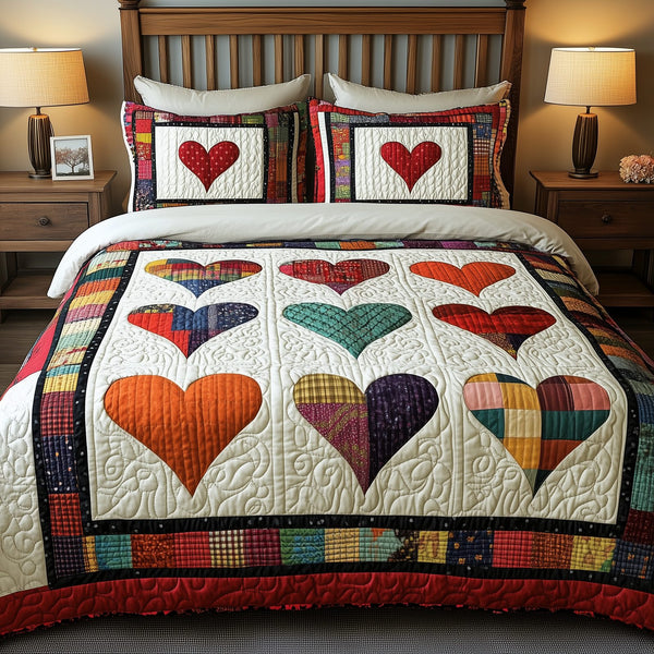 Heart By Heart quilted 3-piece bedding set on a made bed with two matching pillow shams