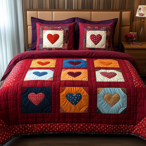 Heart By Heart quilted 3-piece bedding set on a made bed with two matching pillow shams