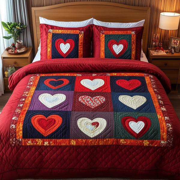Heart By Heart quilted 3-piece bedding set on a made bed with two matching pillow shams