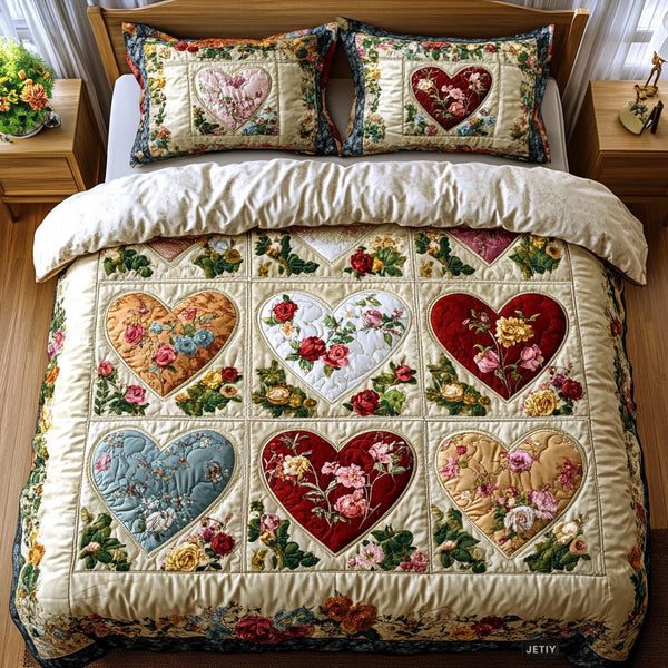 Heart quilted 3-piece bedding set on a made bed with two matching pillow shams