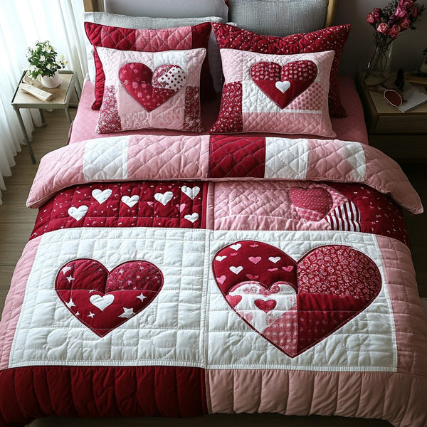 Heart To Heart quilted 3-piece bedding set on a made bed with two matching pillow shams