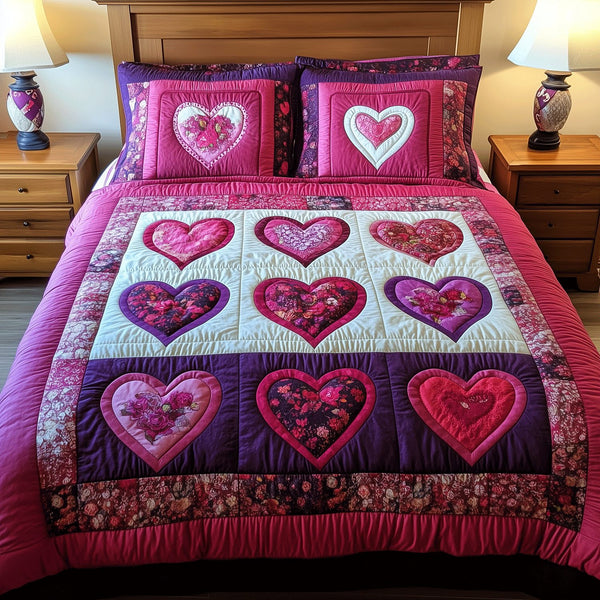 Heart Whispers quilted 3-piece bedding set on a made bed with two matching pillow shams