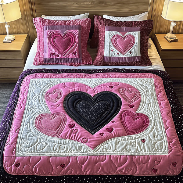 Hearts Aflutter quilted 3-piece bedding set on a made bed with two matching pillow shams