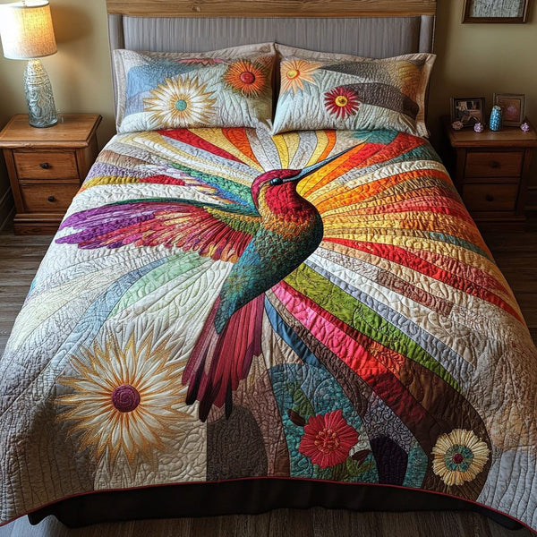 Heavenly Hummingbird quilted 3-piece bedding set on a made bed in a softly lit bedroom