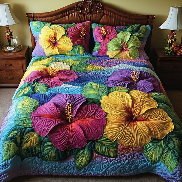 Hibiscus Bloom quilted 3-piece bedding set on a made bed with two matching pillow shams