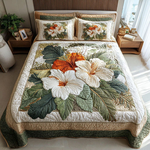 Hibiscus Breeze quilted 3-piece bedding set on a made bed with two matching pillow shams