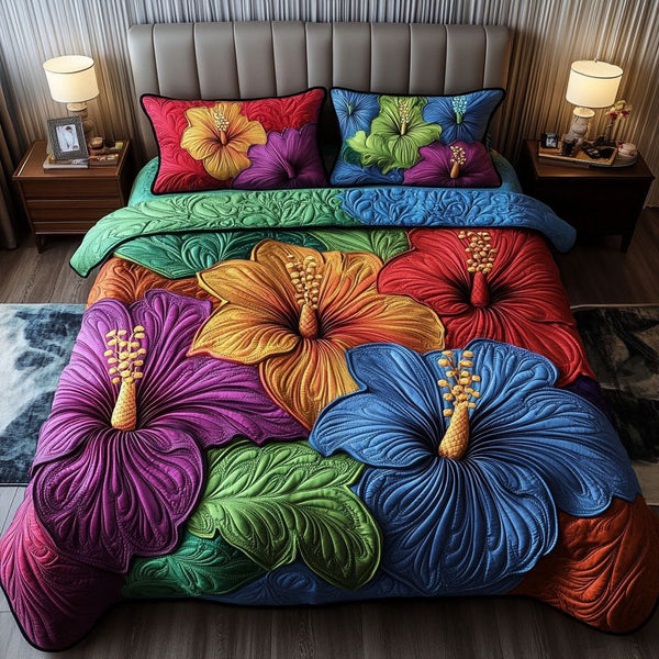 Hibiscus Carnival Colors quilted 3-piece bedding set on a made bed with two matching pillow shams